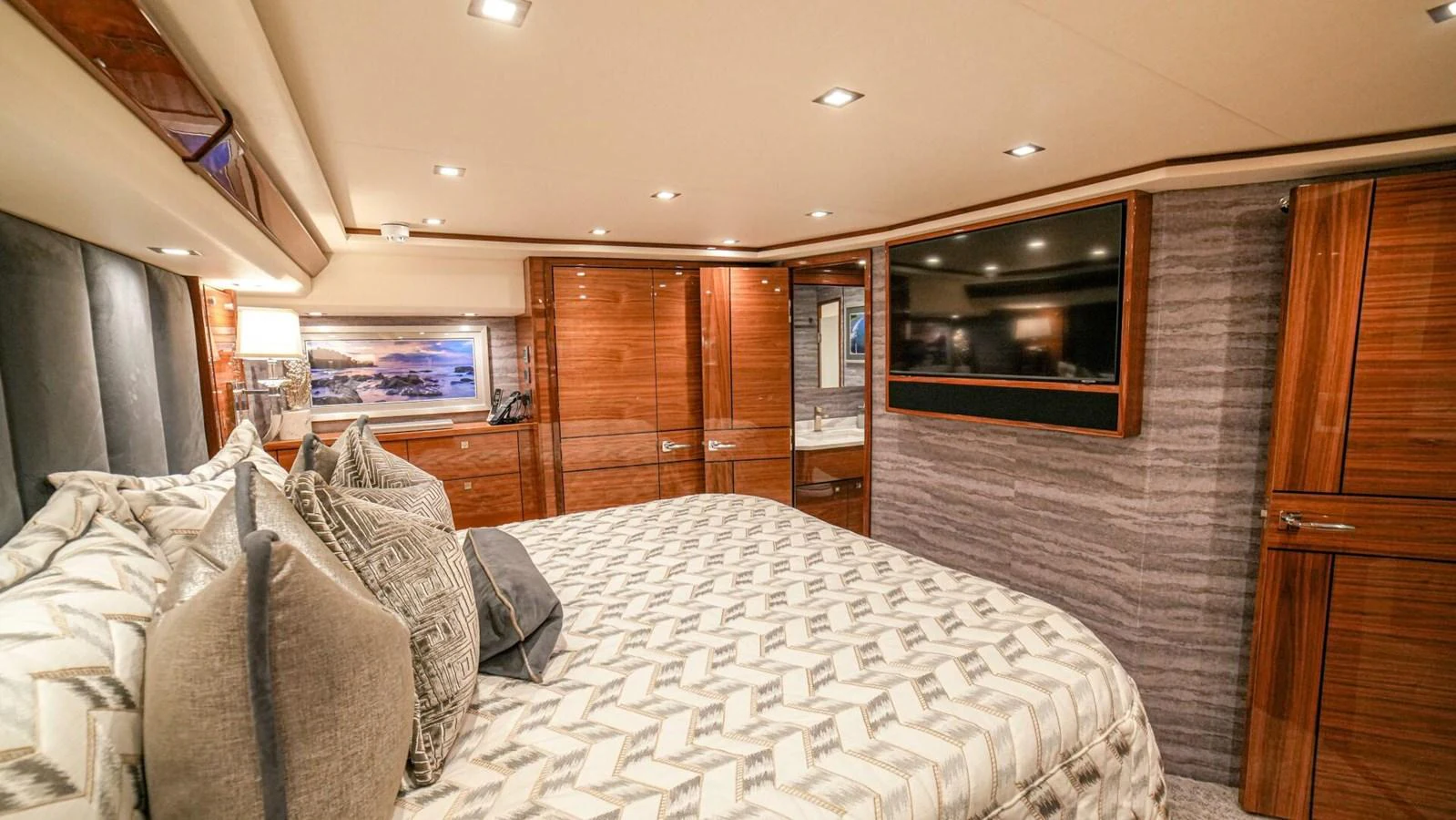 The master stateroom features a luxurious bed, ample storage, and modern entertainment amenities. aboard FREE SPOOL Yacht for Sale