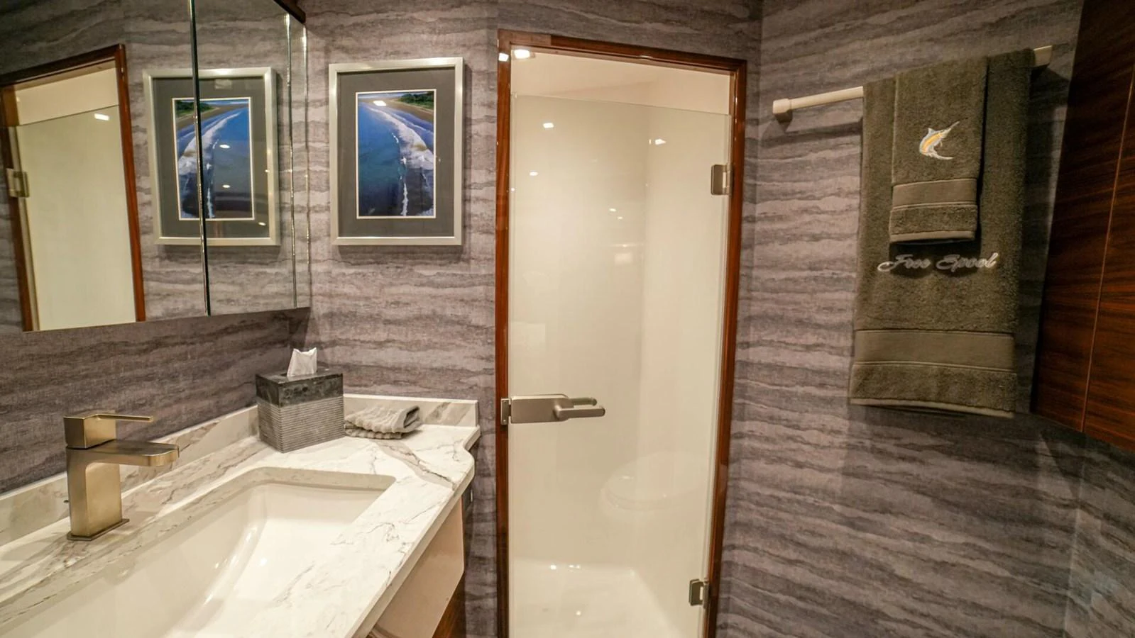 The yacht's bathroom features elegant marble countertops and modern fixtures. aboard FREE SPOOL Yacht for Sale