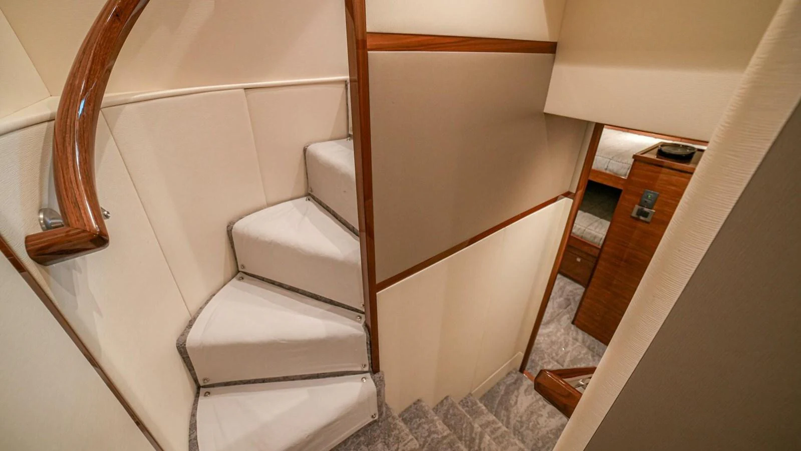 The image showcases a staircase leading to different levels within the yacht's interior. aboard FREE SPOOL Yacht for Sale
