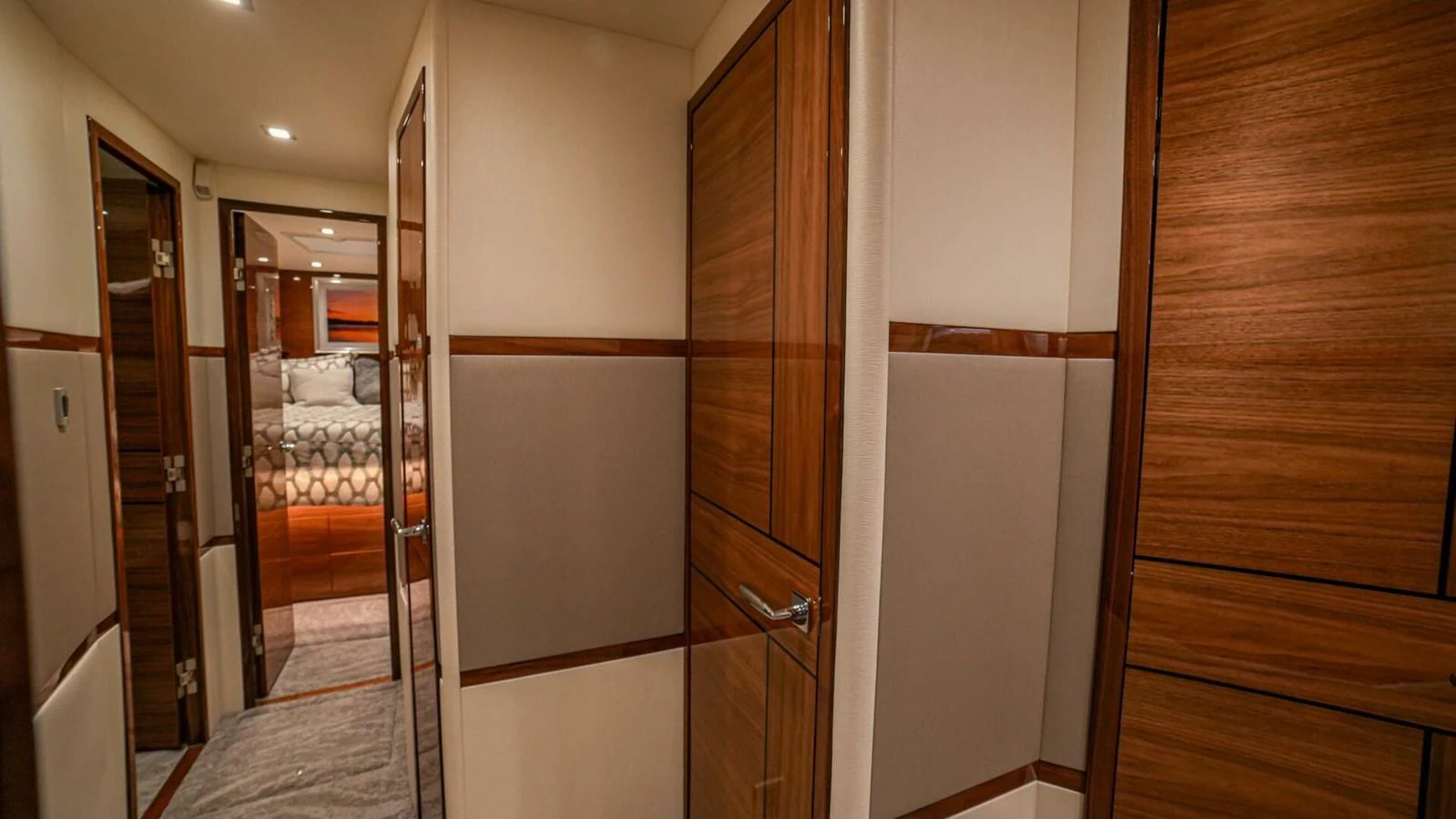 The yacht's hallway features elegant wood paneling and leads to a cozy stateroom. aboard FREE SPOOL Yacht for Sale