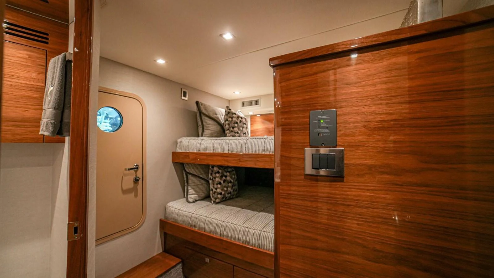 The guest cabin features cozy bunk beds and warm wooden finishes. aboard FREE SPOOL Yacht for Sale