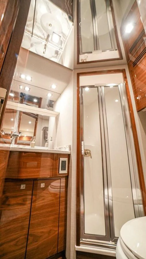 The yacht's bathroom features elegant wood cabinetry and modern fixtures. aboard FREE SPOOL Yacht for Sale