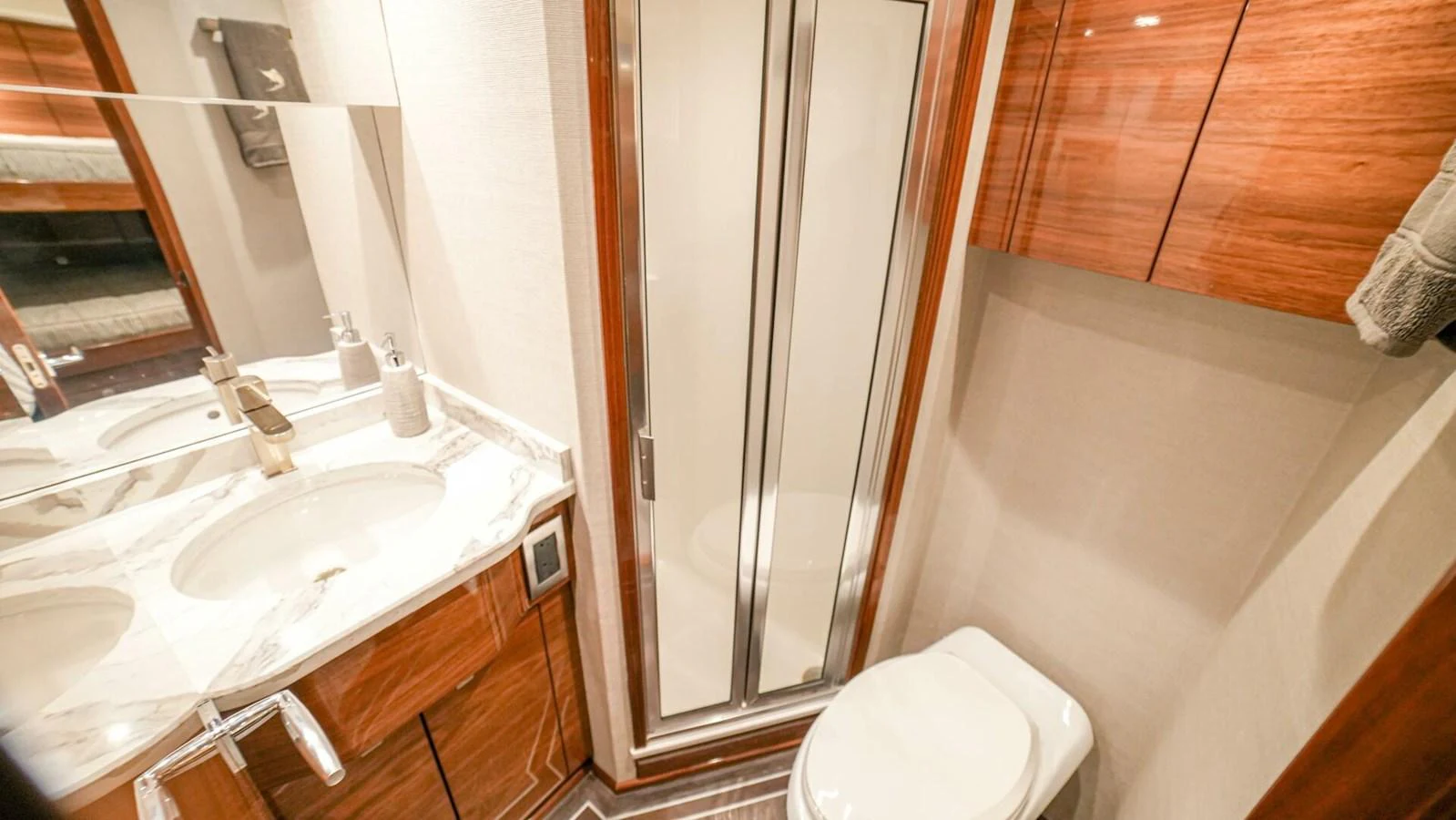 The yacht's bathroom features a sleek design with modern fixtures and wooden cabinetry. aboard FREE SPOOL Yacht for Sale