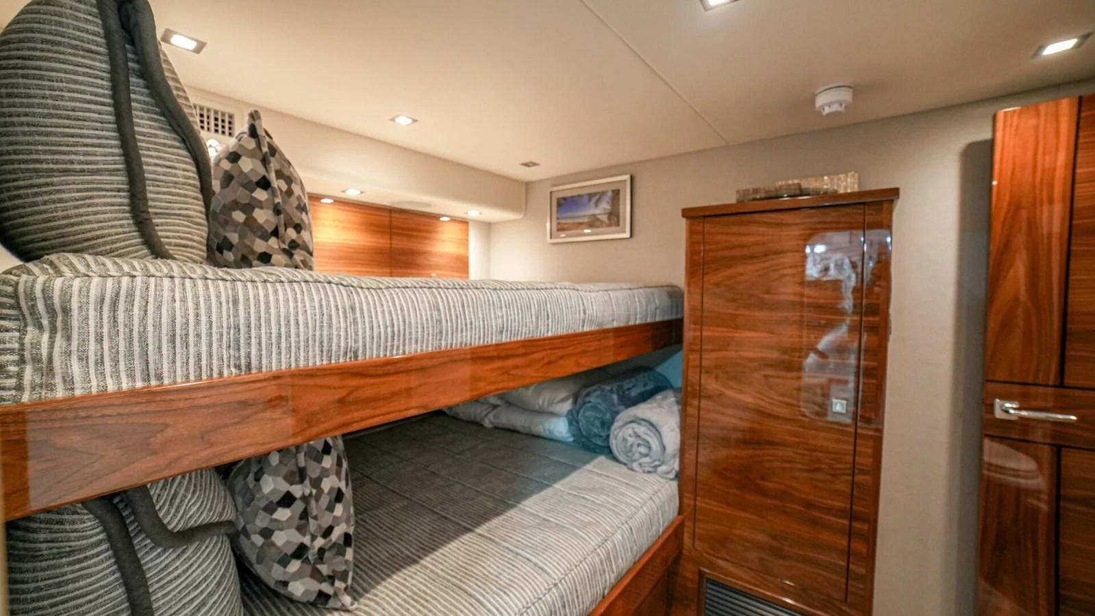 A cozy cabin featuring wooden bunk beds and modern amenities. aboard FREE SPOOL Yacht for Sale