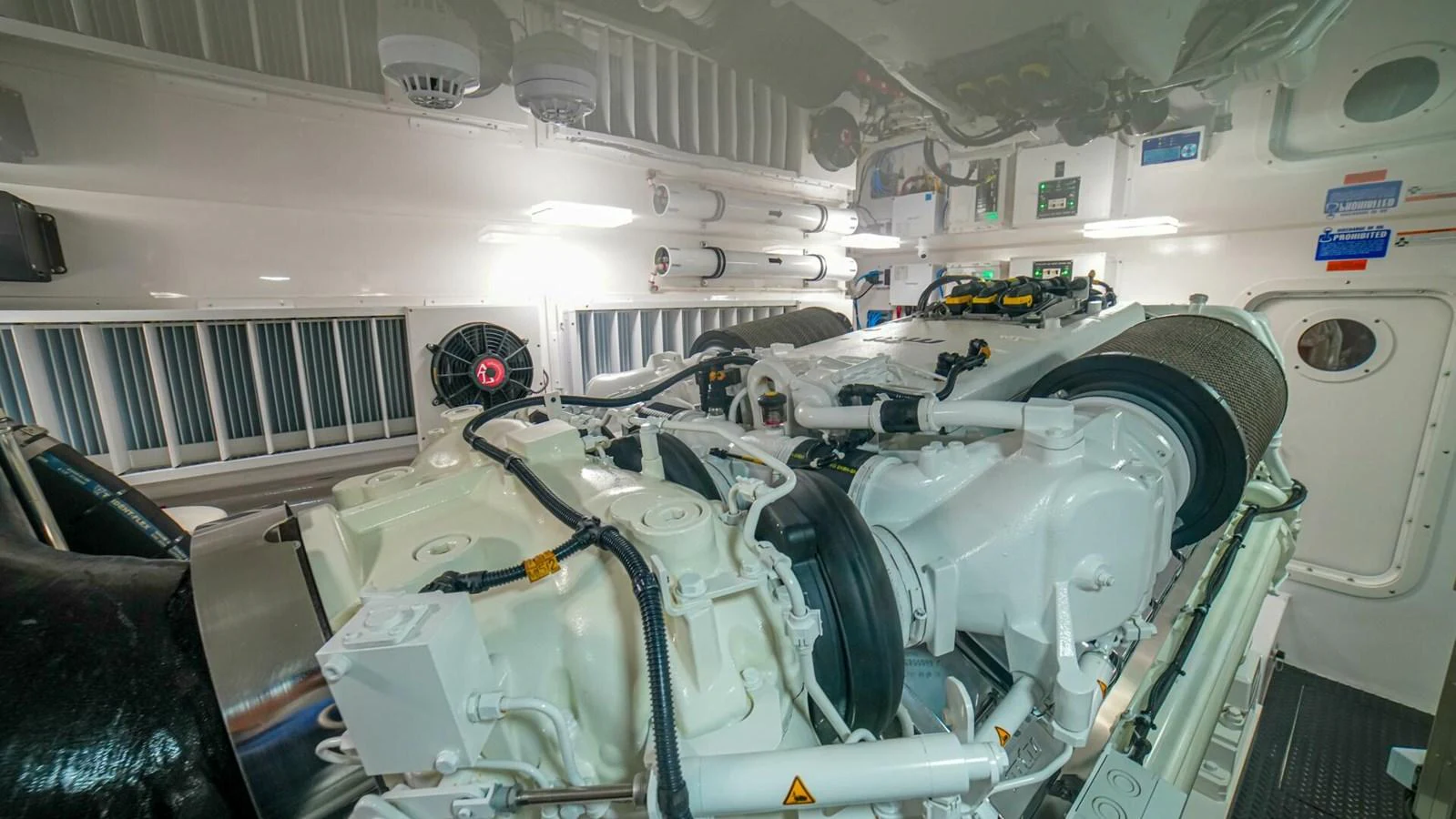 The yacht's engine room showcases powerful machinery and a clean, organized space. aboard FREE SPOOL Yacht for Sale