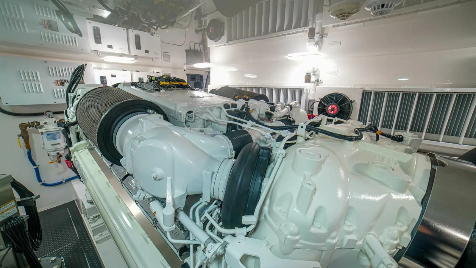 The yacht's engine room showcases powerful machinery and a clean, organized space. aboard FREE SPOOL Yacht for Sale