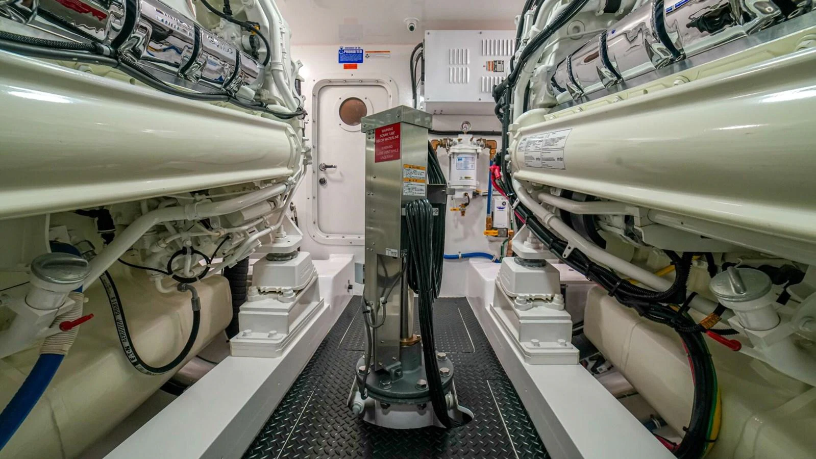 The image showcases a pristine and well-organized engine room with advanced machinery and equipment. aboard FREE SPOOL Yacht for Sale