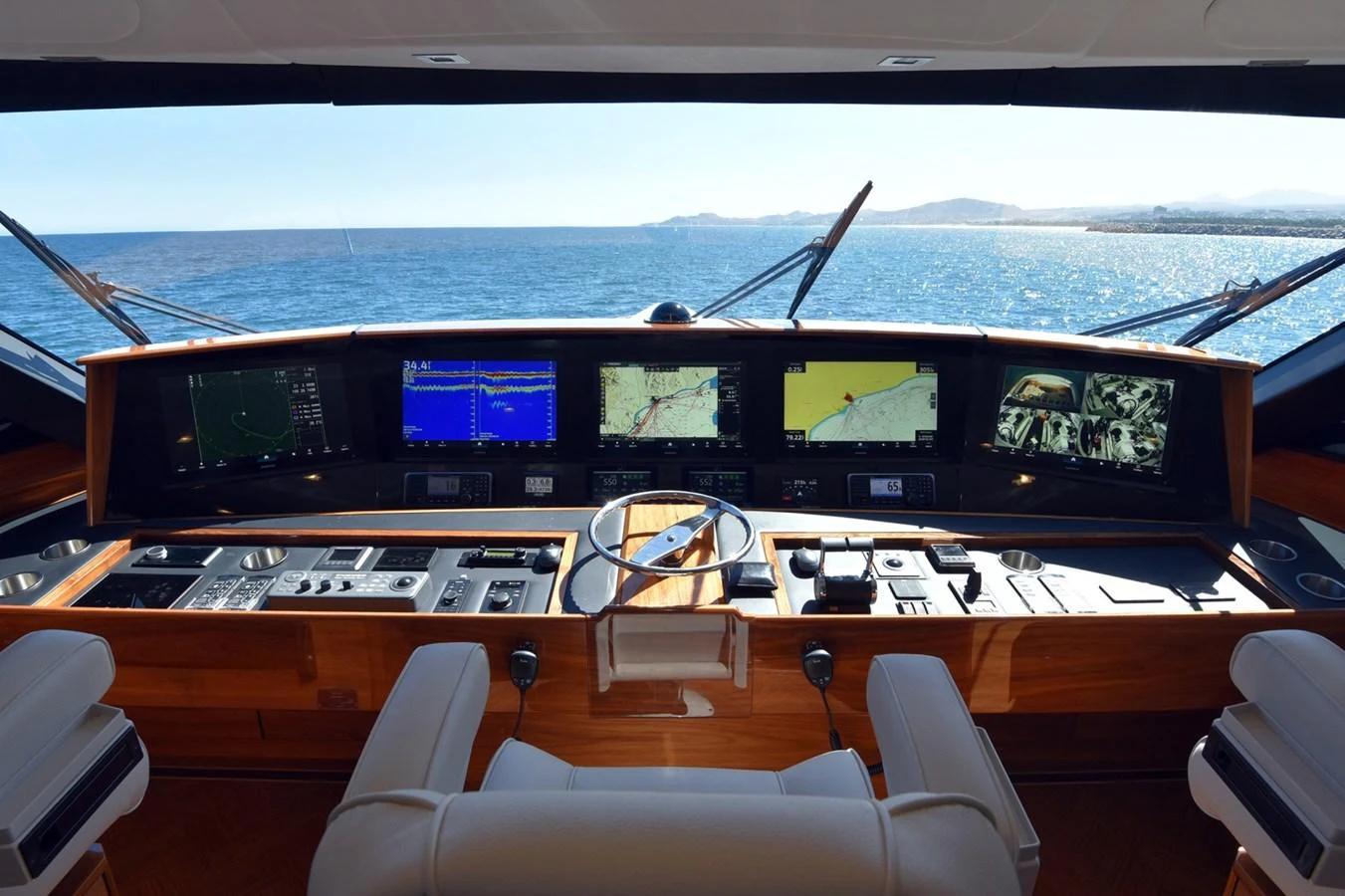 The helm station offers advanced navigation systems with a panoramic view of the sea. aboard PRIMETIME Yacht for Sale