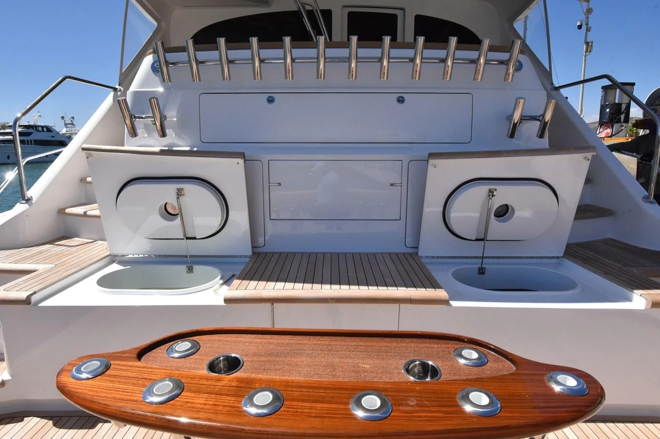 The aft deck features a well-equipped fishing station with multiple rod holders and bait prep areas. aboard PRIMETIME Yacht for Sale