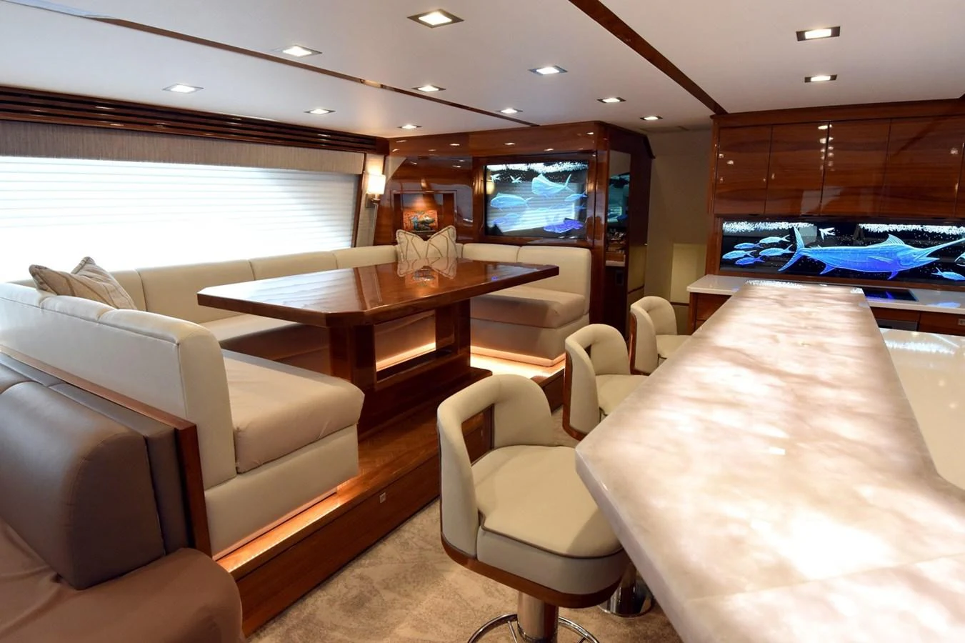 The yacht's salon features elegant seating and a stylish dining area with modern lighting. aboard PRIMETIME Yacht for Sale