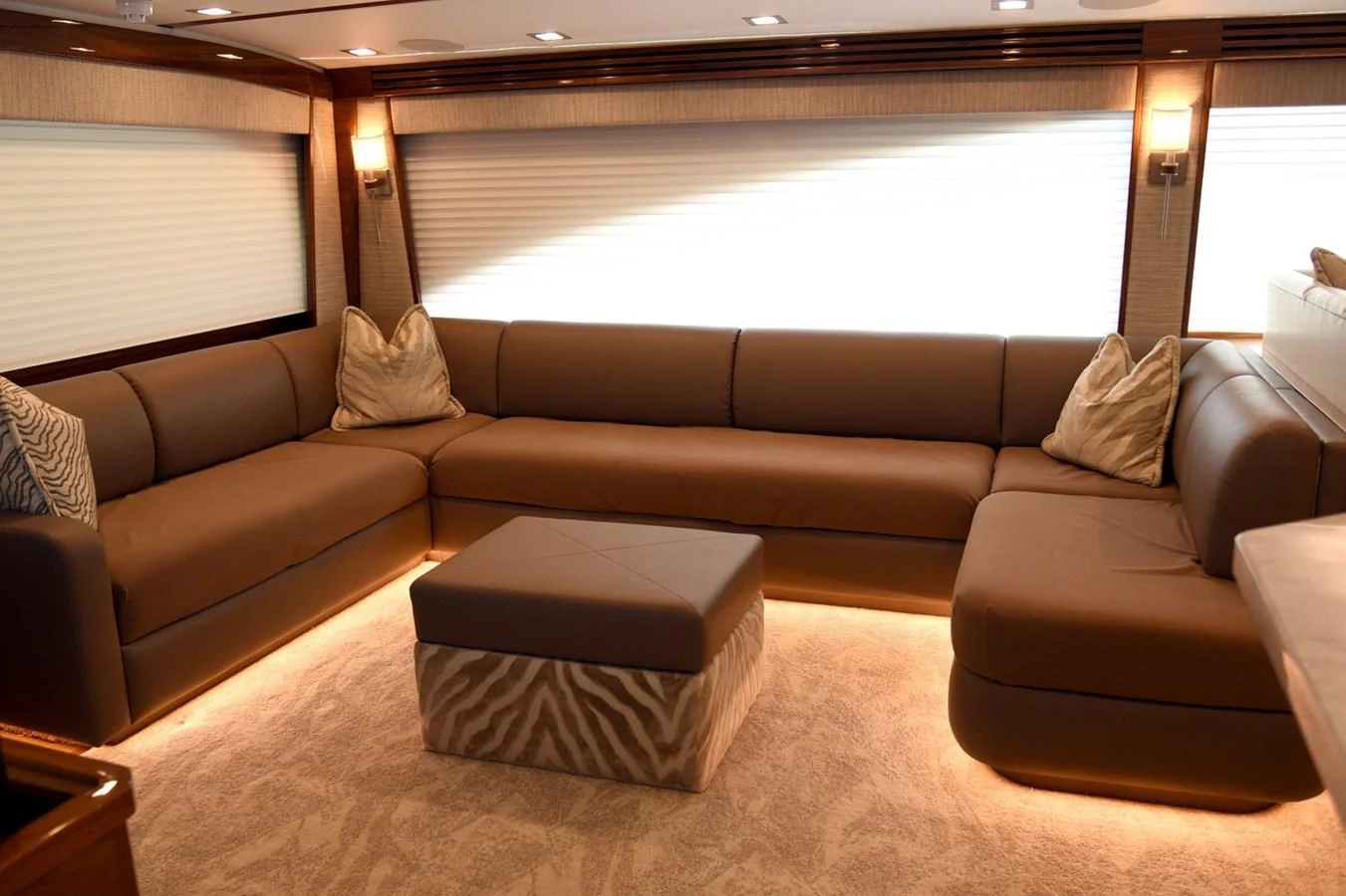The salon features a spacious and comfortable seating area with elegant lighting. aboard PRIMETIME Yacht for Sale