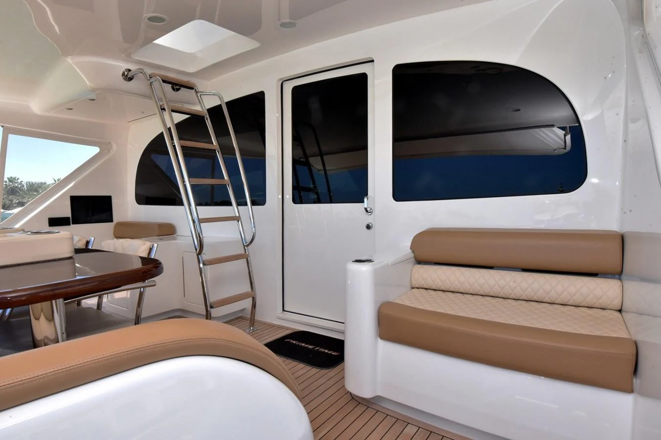 The aft deck features comfortable seating and a dining area, perfect for relaxation and entertaining. aboard PRIMETIME Yacht for Sale