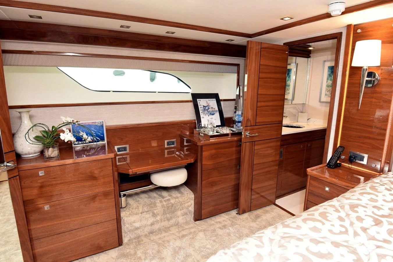 The stateroom features elegant wood cabinetry and a cozy ambiance. aboard PRIMETIME Yacht for Sale