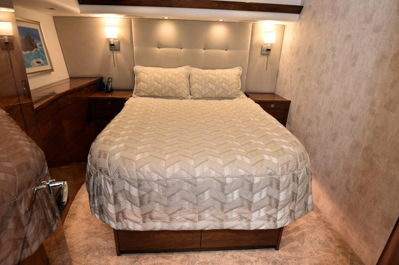 The stateroom features a comfortable bed with elegant bedding and soft lighting. aboard PRIMETIME Yacht for Sale