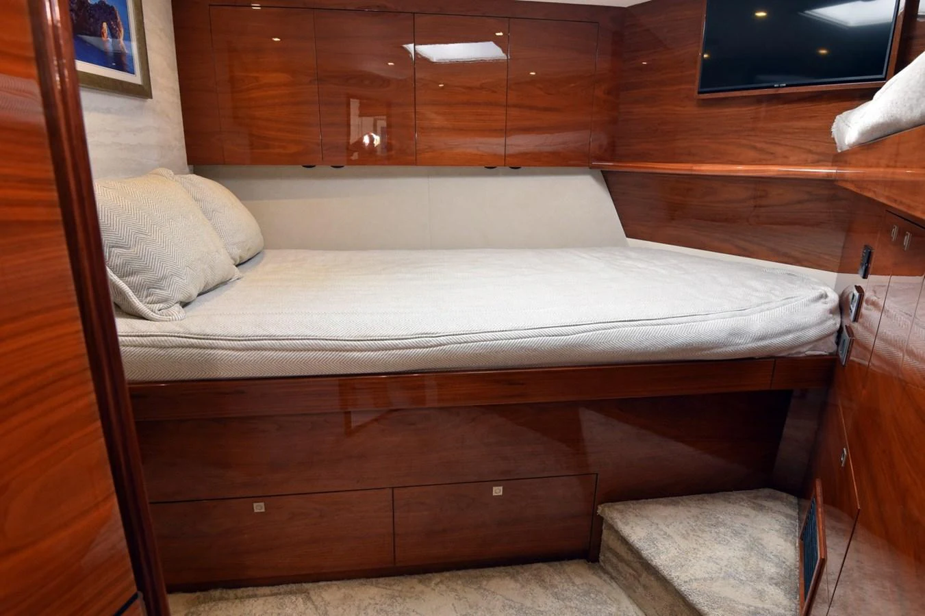 A cozy stateroom featuring a comfortable bed and elegant wooden cabinetry. aboard PRIMETIME Yacht for Sale
