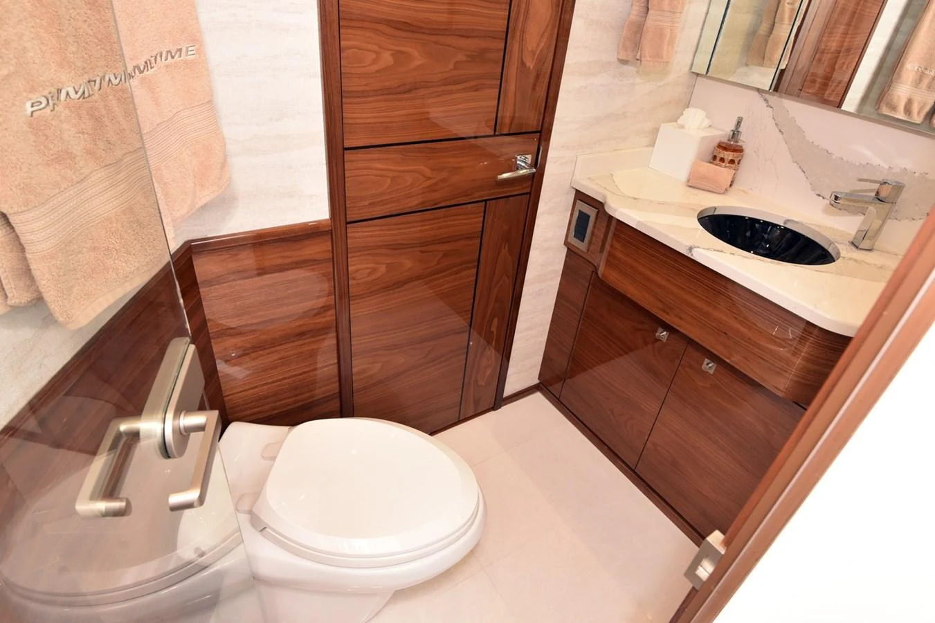 The yacht's head features elegant wood paneling and modern fixtures. aboard PRIMETIME Yacht for Sale