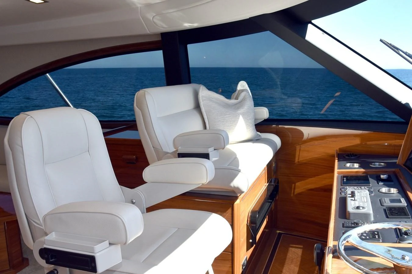 The helm area features comfortable seating and advanced navigation equipment. aboard PRIMETIME Yacht for Sale