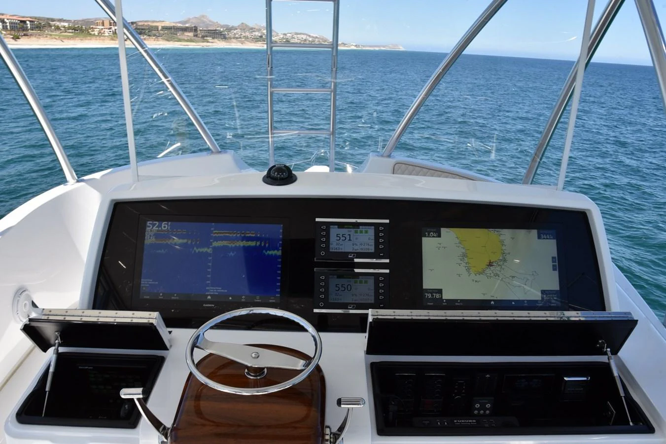 The helm station features advanced navigation equipment and a sleek steering wheel. aboard PRIMETIME Yacht for Sale