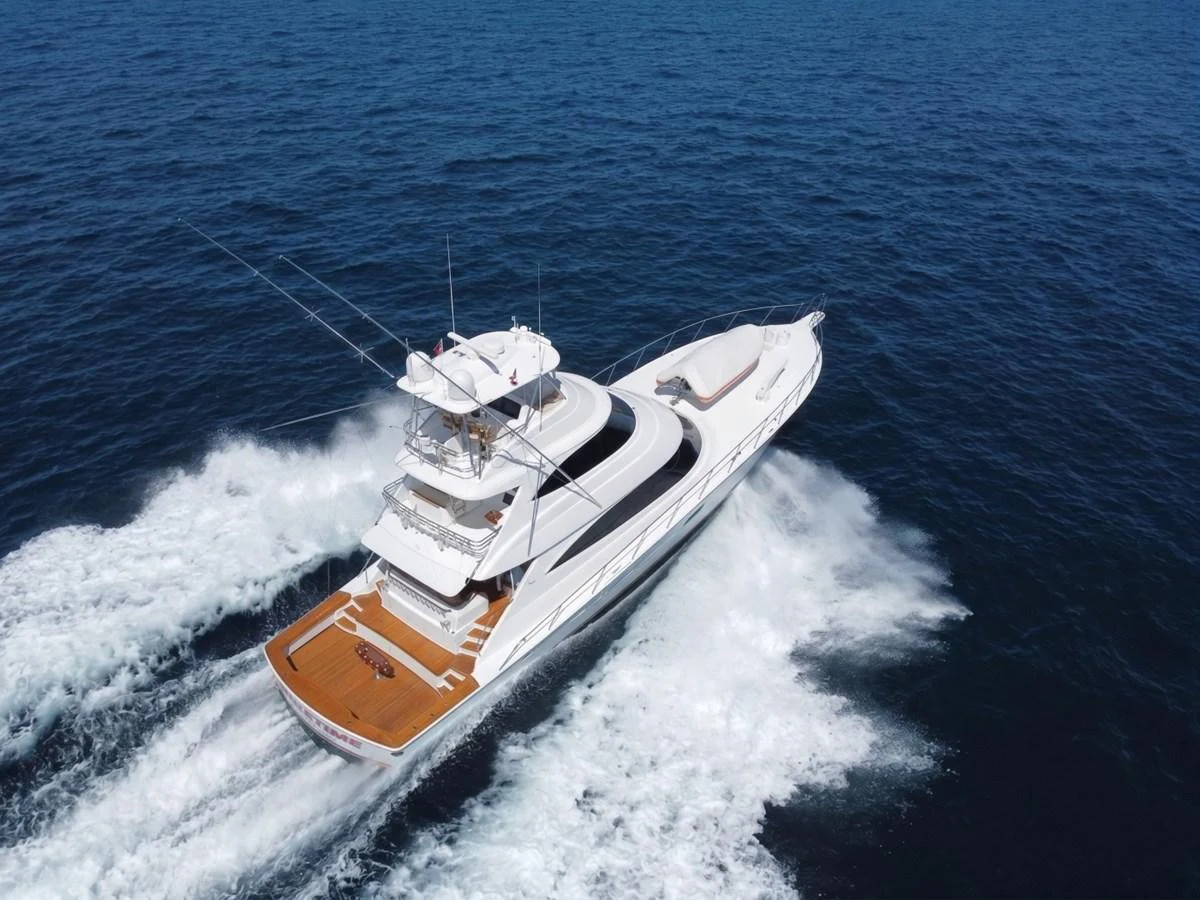 A sleek yacht cruises swiftly through the open sea, showcasing its elegant design and spacious deck. aboard PRIMETIME Yacht for Sale