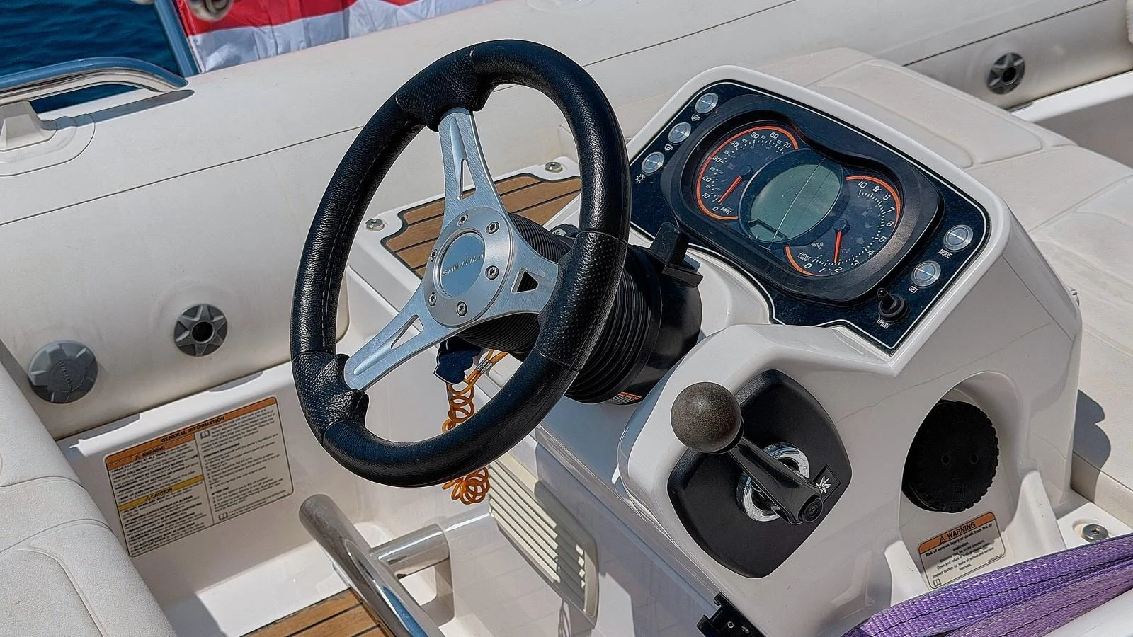 The helm station features a sleek steering wheel and modern instrumentation. aboard GANS Yacht for Sale