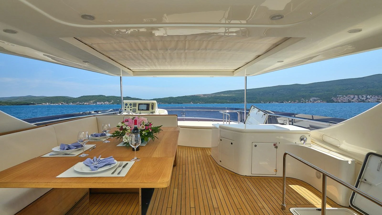The aft deck features a spacious dining area with stunning views of the water. aboard GANS Yacht for Sale
