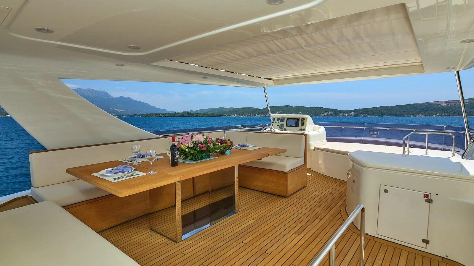 The flybridge offers a spacious dining area with stunning ocean views. aboard GANS Yacht for Sale