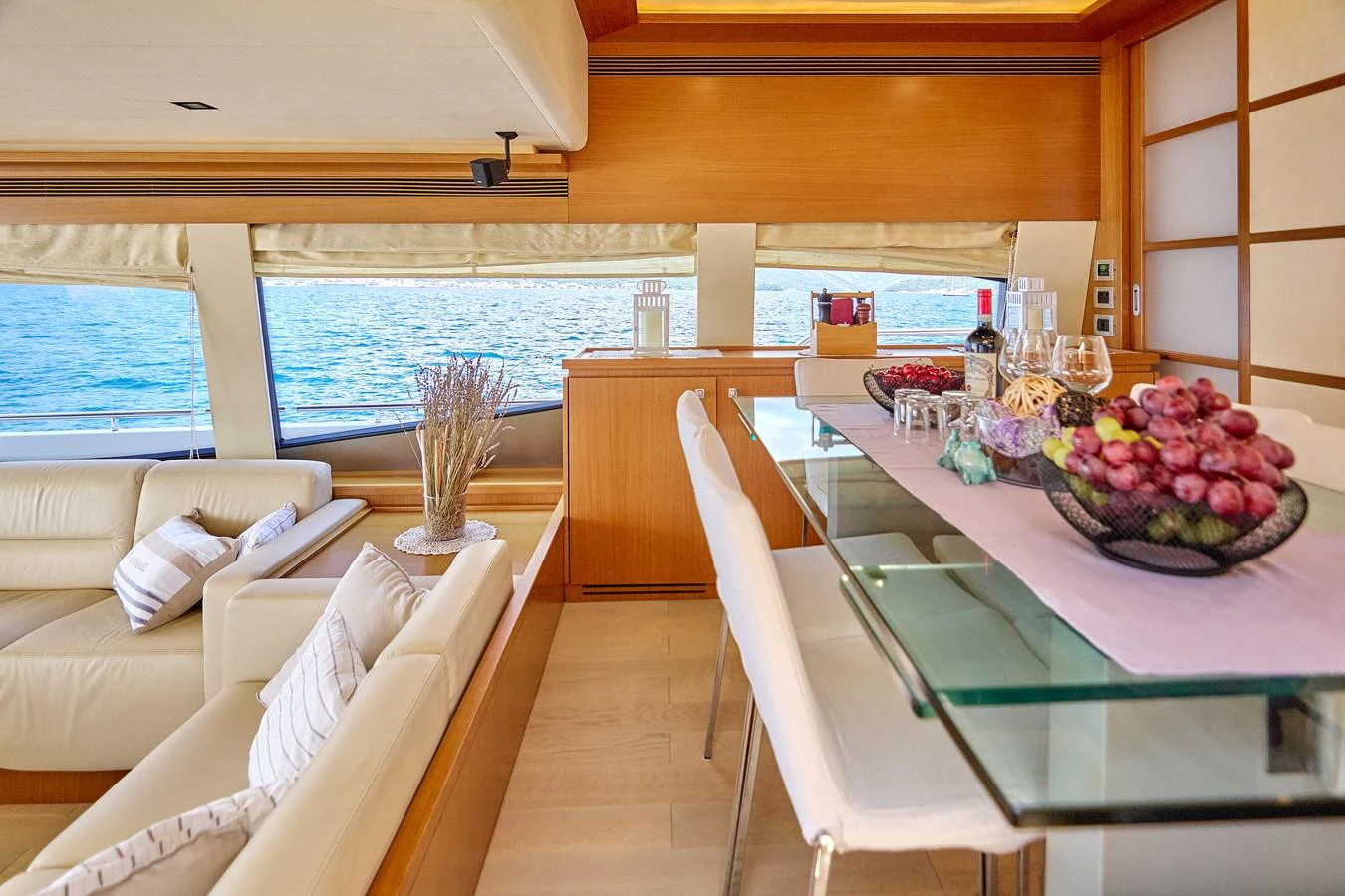 The salon features comfortable seating and a stylish dining area with a view of the sea. aboard GANS Yacht for Sale