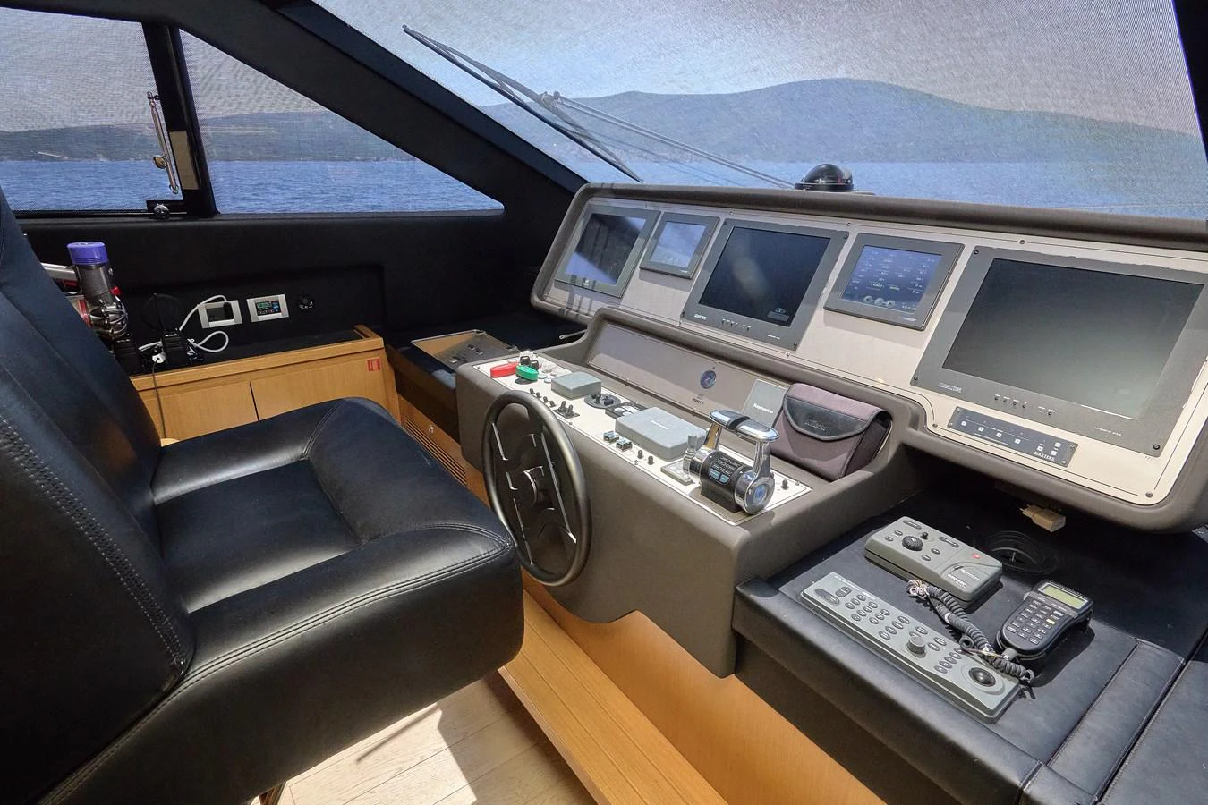 The helm station features advanced navigation equipment and a comfortable captain's chair. aboard GANS Yacht for Sale