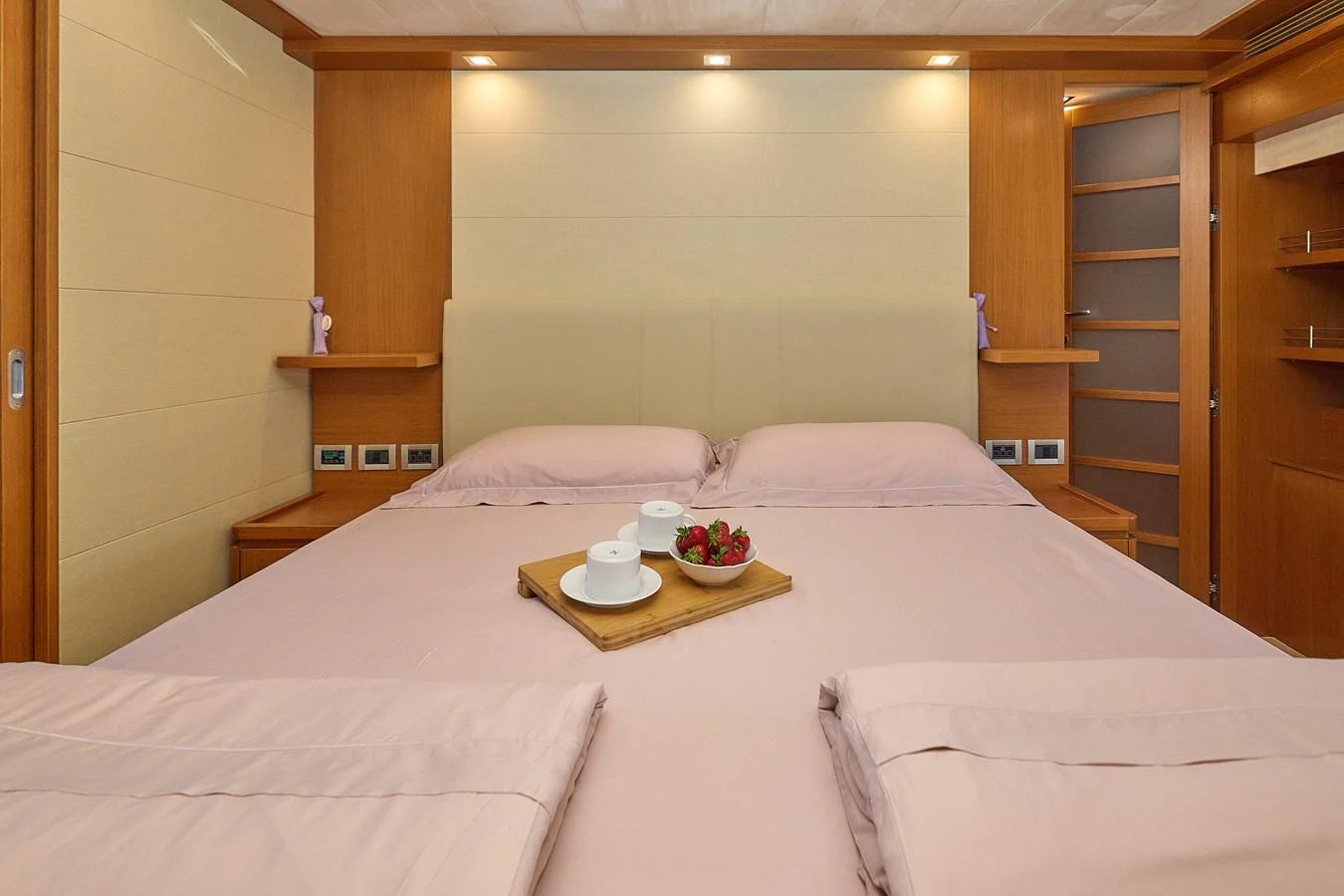 The master stateroom features a spacious bed with elegant bedding and a tray of refreshments. aboard GANS Yacht for Sale