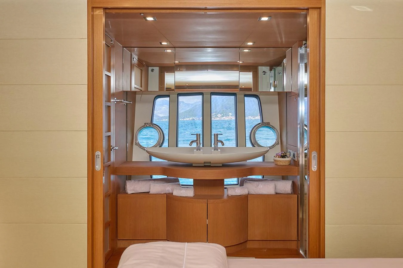 A cozy interior view featuring a wooden finish and large windows overlooking the water. aboard GANS Yacht for Sale