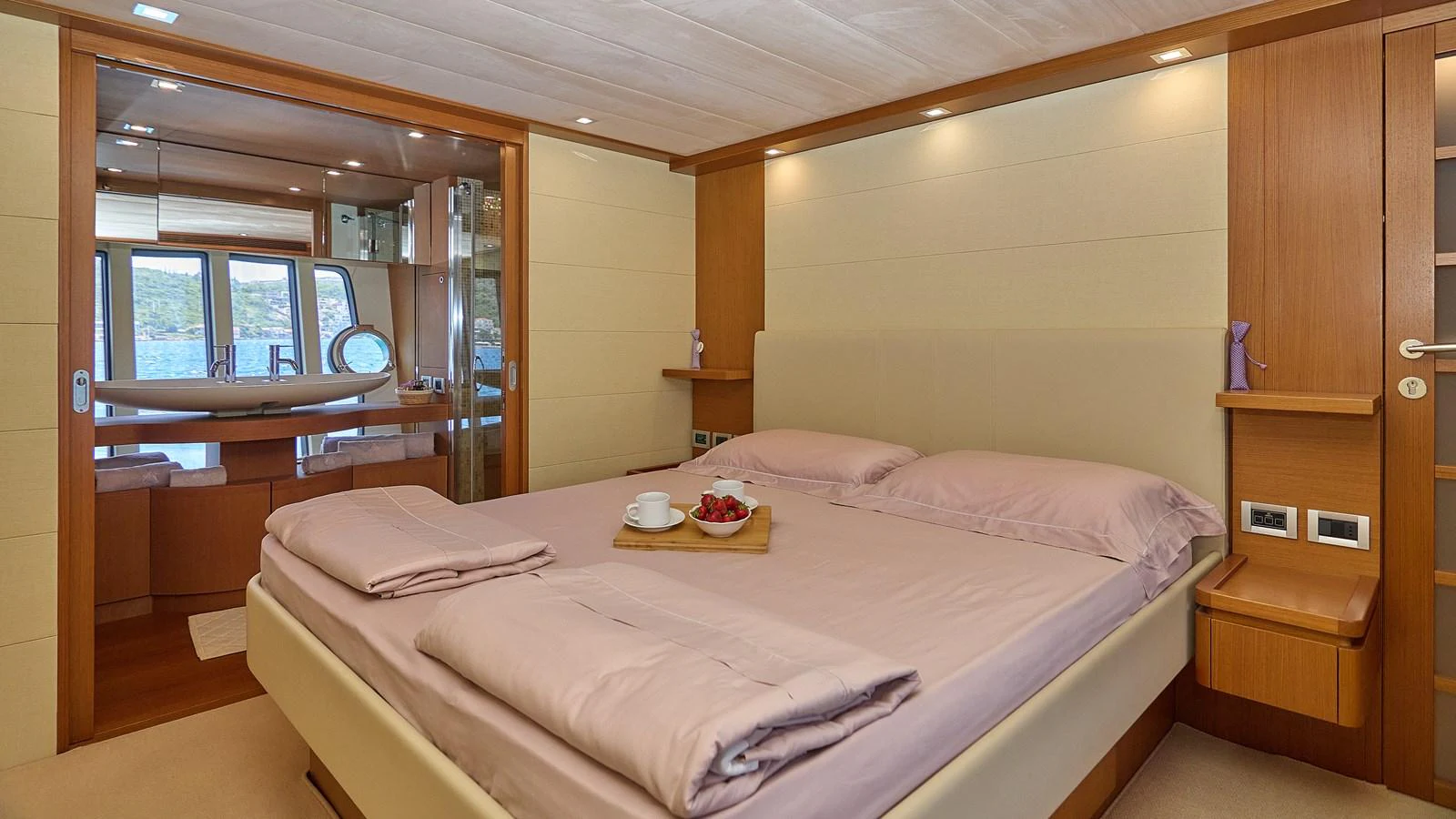 The master stateroom features a comfortable bed with luxurious linens and a tray of refreshments. aboard GANS Yacht for Sale