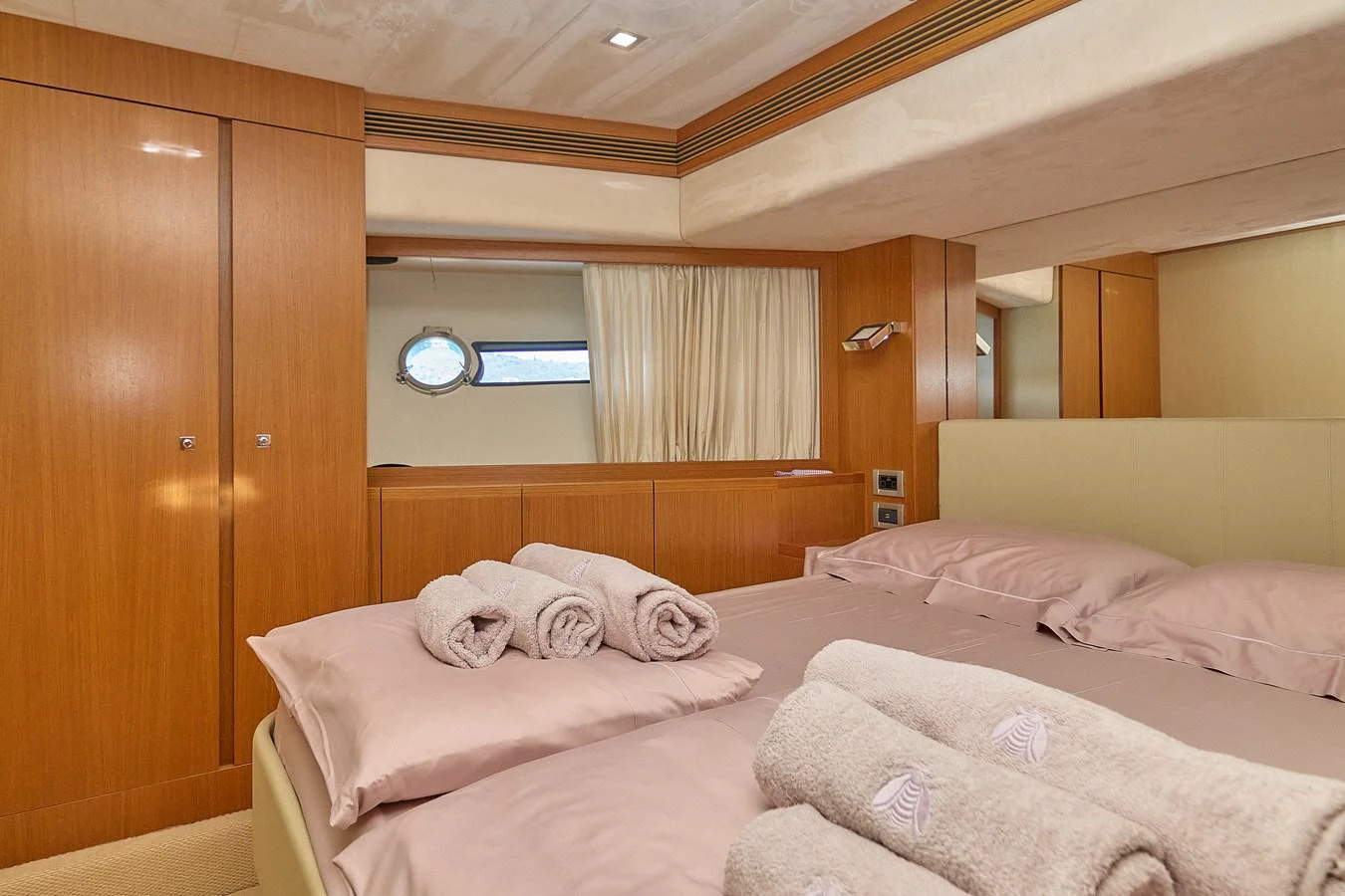 The stateroom features a comfortable bed with neatly arranged towels, offering a cozy and inviting atmosphere. aboard GANS Yacht for Sale