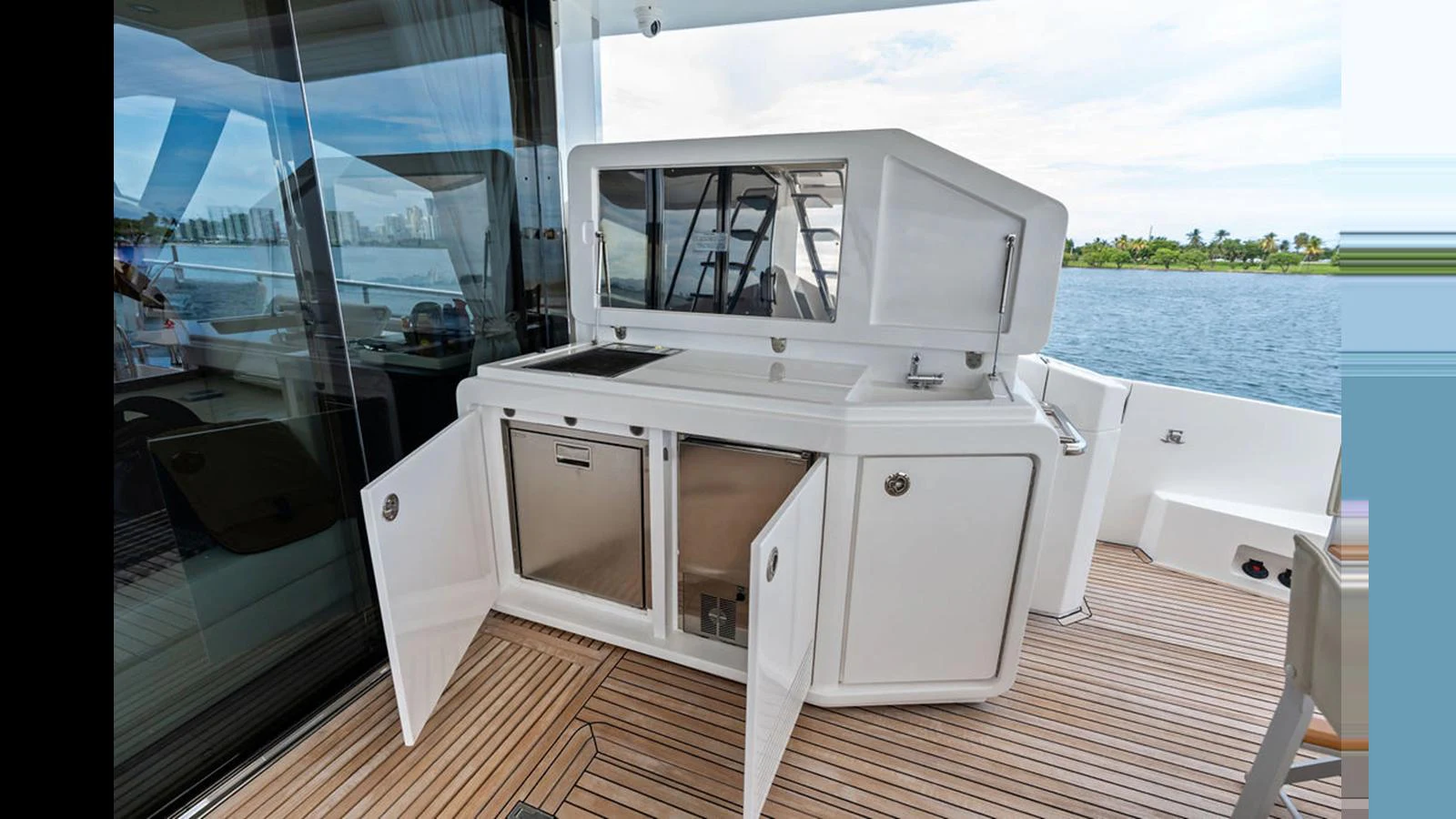 The aft deck features a sleek outdoor kitchenette with ample storage and a beautiful view of the water. aboard VILLAGGIO Yacht for Sale