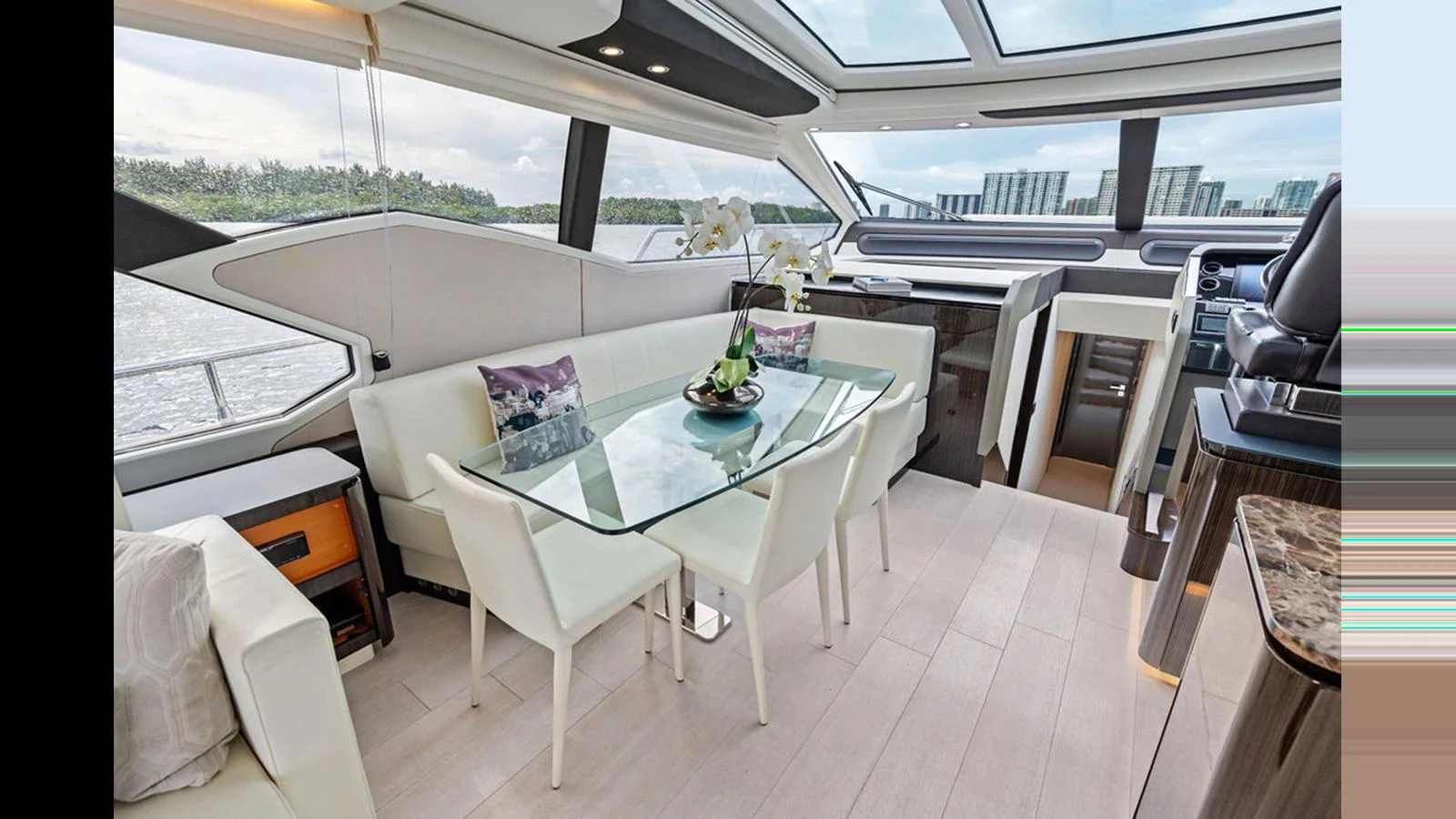 The salon features a modern dining area with panoramic windows offering stunning views. aboard VILLAGGIO Yacht for Sale