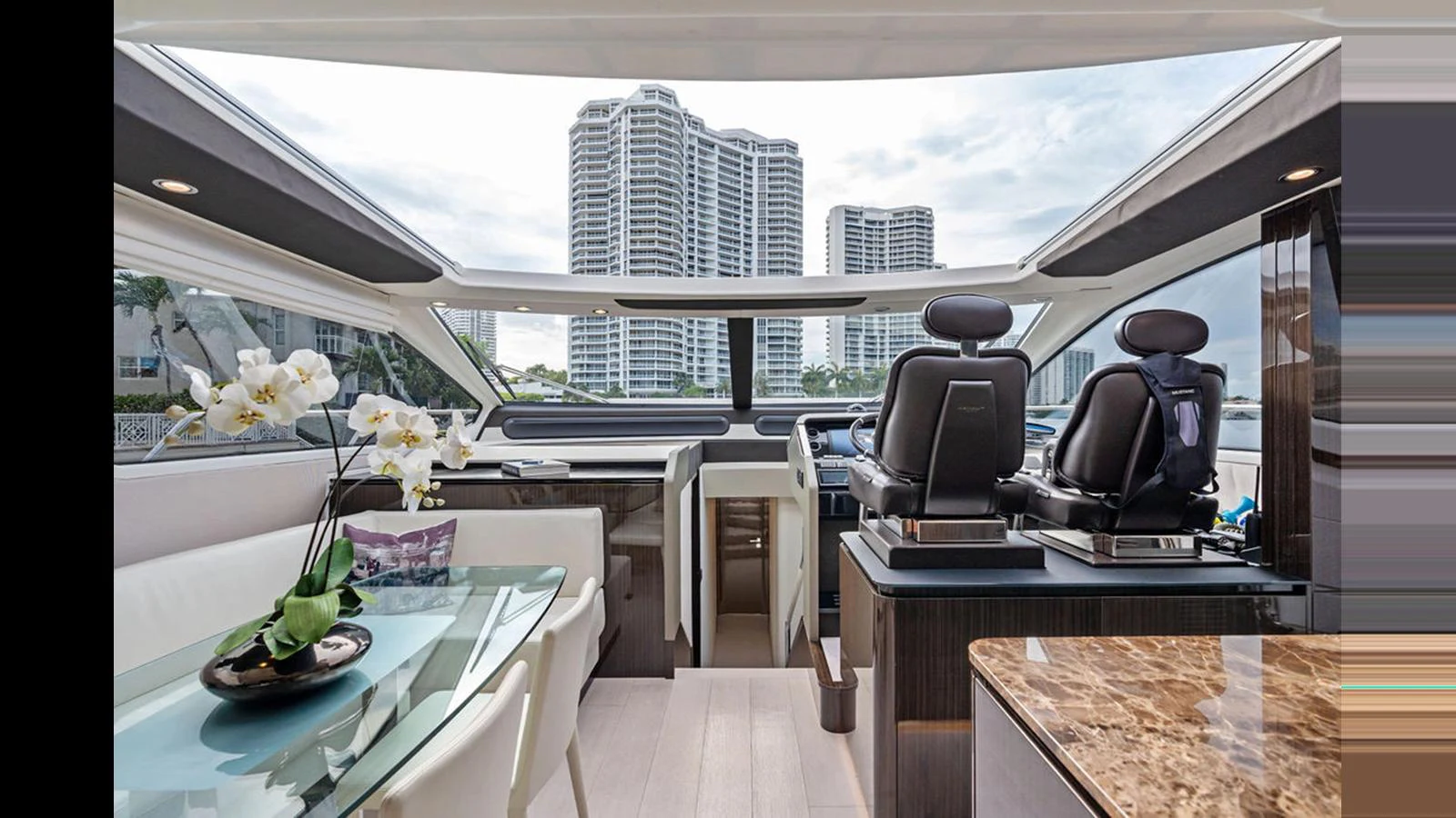 The yacht's helm area features modern seating and a sleek design with large windows offering expansive views. aboard VILLAGGIO Yacht for Sale