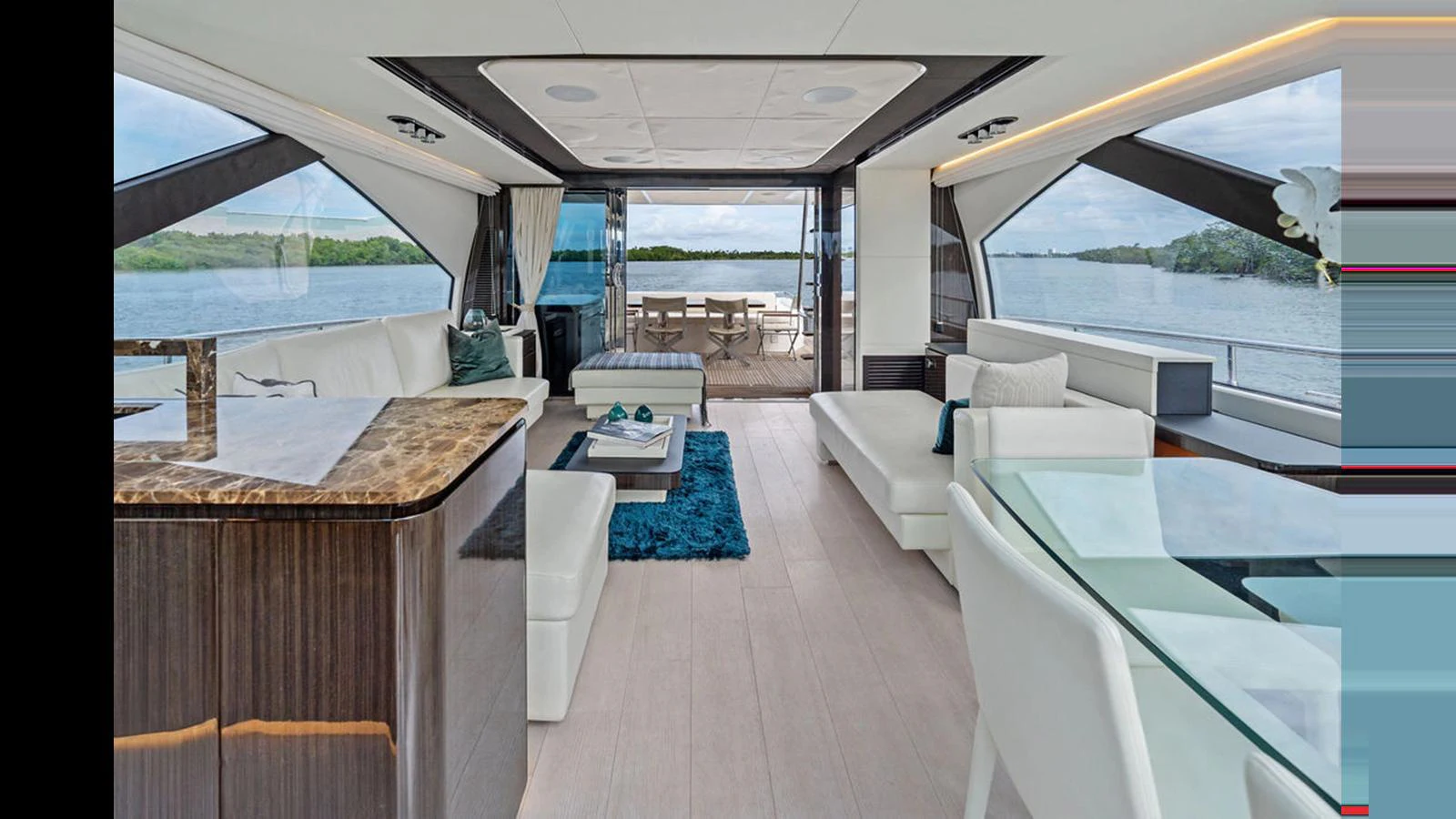 The yacht's interior features a spacious and elegant living area with modern furnishings and large windows offering stunning views. aboard VILLAGGIO Yacht for Sale