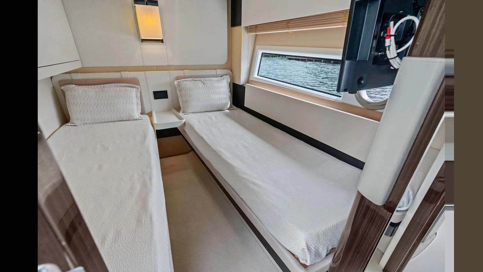The guest stateroom features twin beds and a window with a view of the water. aboard VILLAGGIO Yacht for Sale