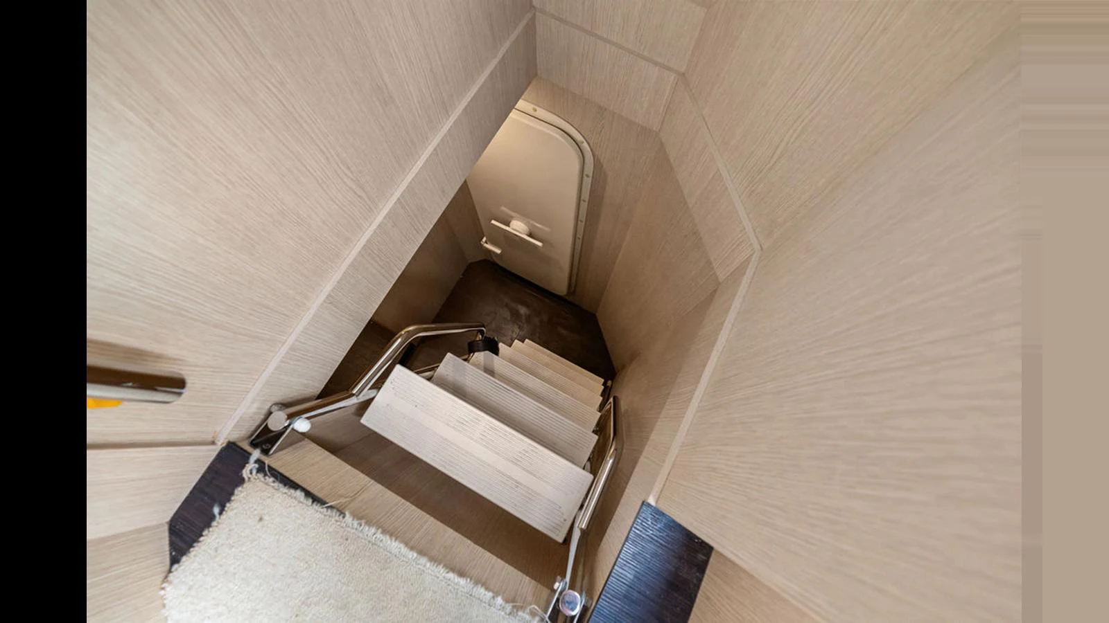 A well-lit staircase leads down to a lower deck area. aboard VILLAGGIO Yacht for Sale
