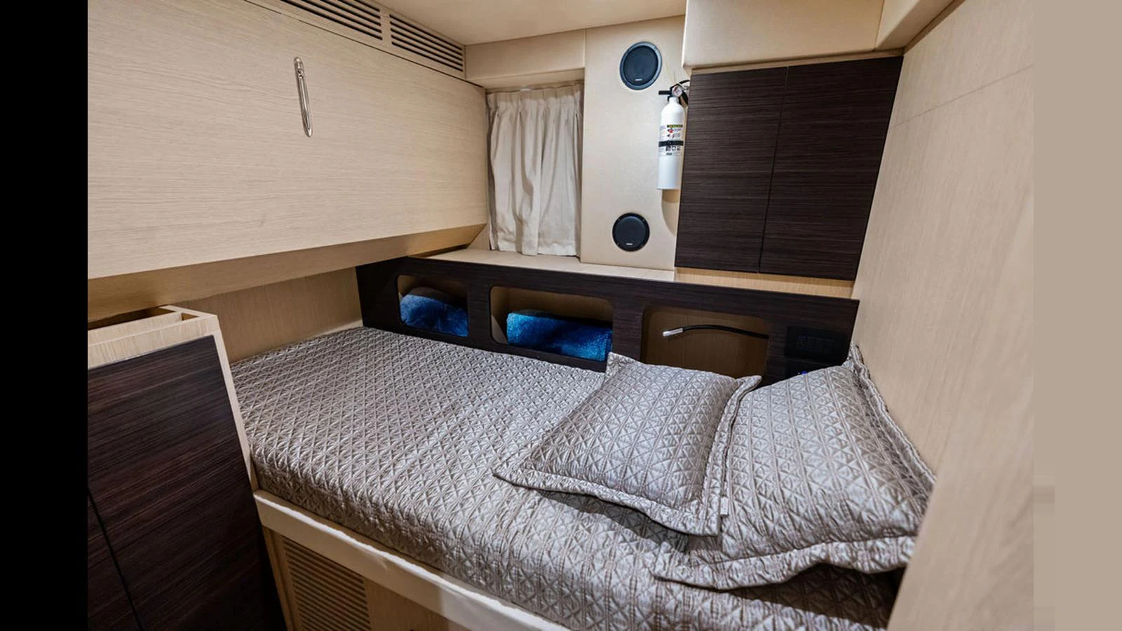 A cozy stateroom with a neatly made bed and modern furnishings. aboard VILLAGGIO Yacht for Sale