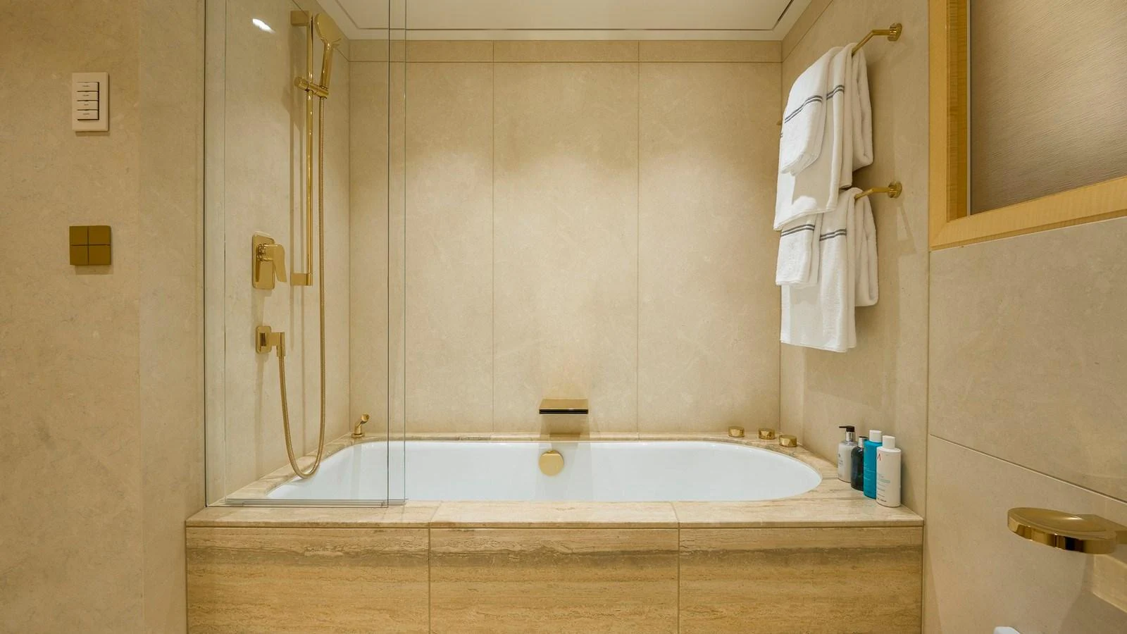 A luxurious bathroom featuring a bathtub with elegant fixtures and neatly arranged towels. aboard NENINKA Yacht for Sale