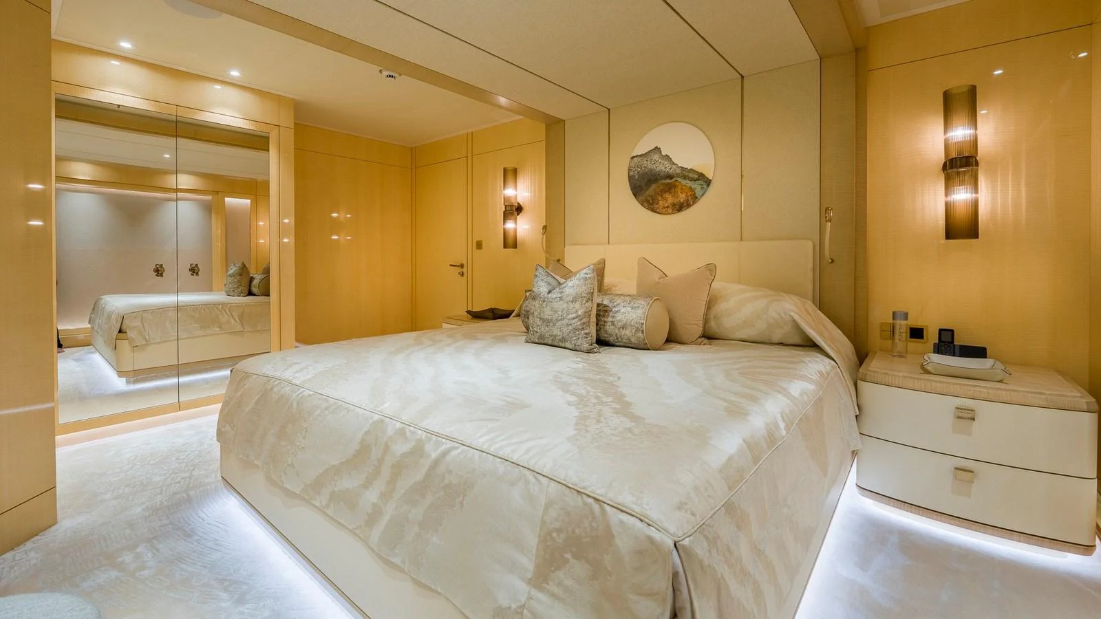 The master stateroom features a luxurious bed with elegant bedding and modern lighting. aboard NENINKA Yacht for Sale