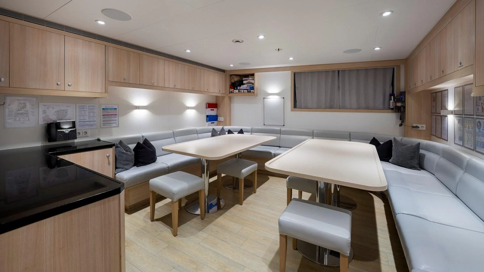 The crew mess area features comfortable seating and dining tables, creating a welcoming environment for the crew. aboard NENINKA Yacht for Sale
