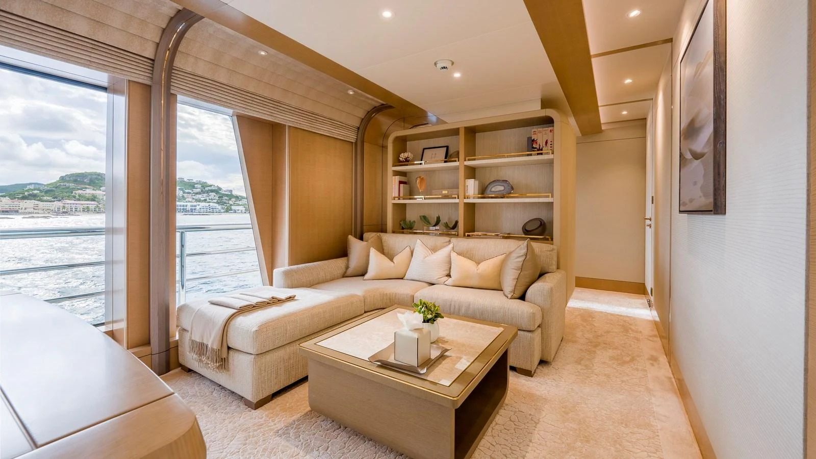 The salon features a comfortable seating area with elegant decor and large windows offering scenic views. aboard NENINKA Yacht for Sale