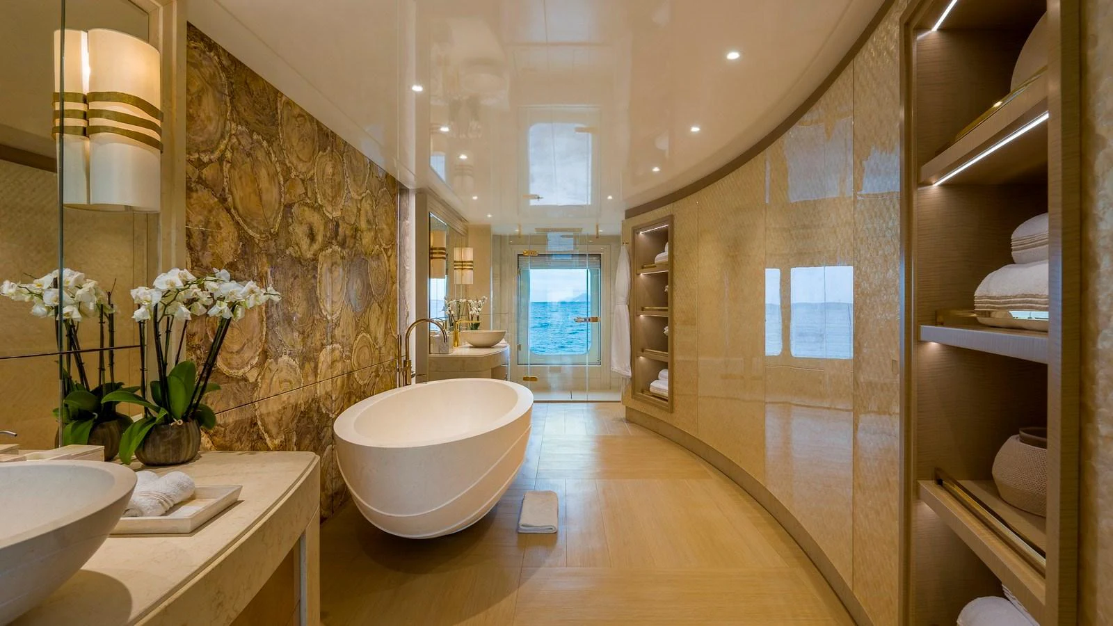 This luxurious bathroom features elegant fixtures and a stunning view of the sea. aboard NENINKA Yacht for Sale