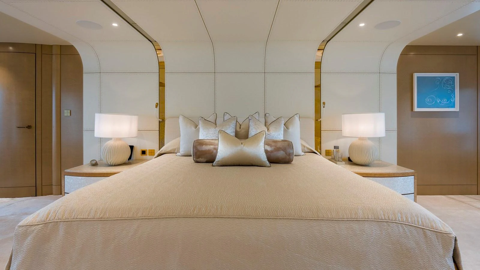 The master stateroom features a luxurious bed with elegant decor and ambient lighting. aboard NENINKA Yacht for Sale