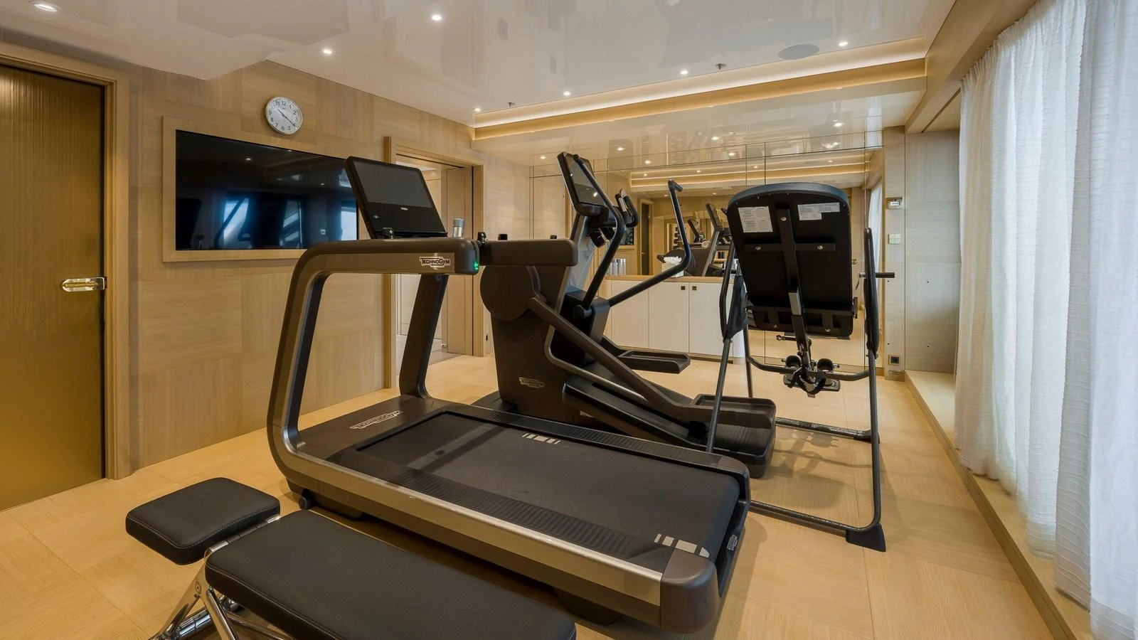 The yacht features a well-equipped gym with modern exercise machines. aboard NENINKA Yacht for Sale