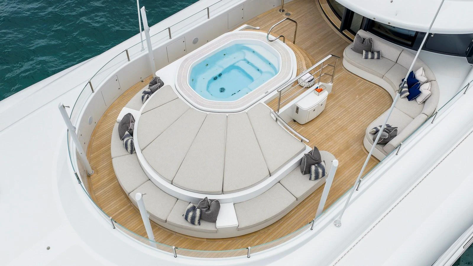 The sundeck features a luxurious jacuzzi surrounded by ample seating and elegant design. aboard NENINKA Yacht for Sale