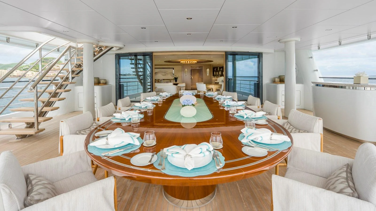 The yacht features a spacious and elegant dining area with a large table set for a meal. aboard NENINKA Yacht for Sale