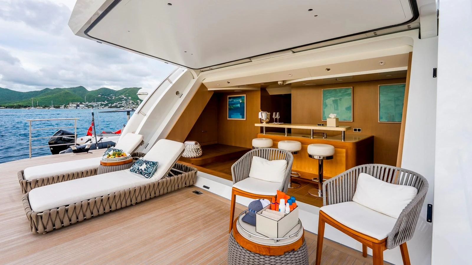 The aft deck features comfortable lounge chairs and a stylish bar area, perfect for relaxation and entertainment. aboard NENINKA Yacht for Sale