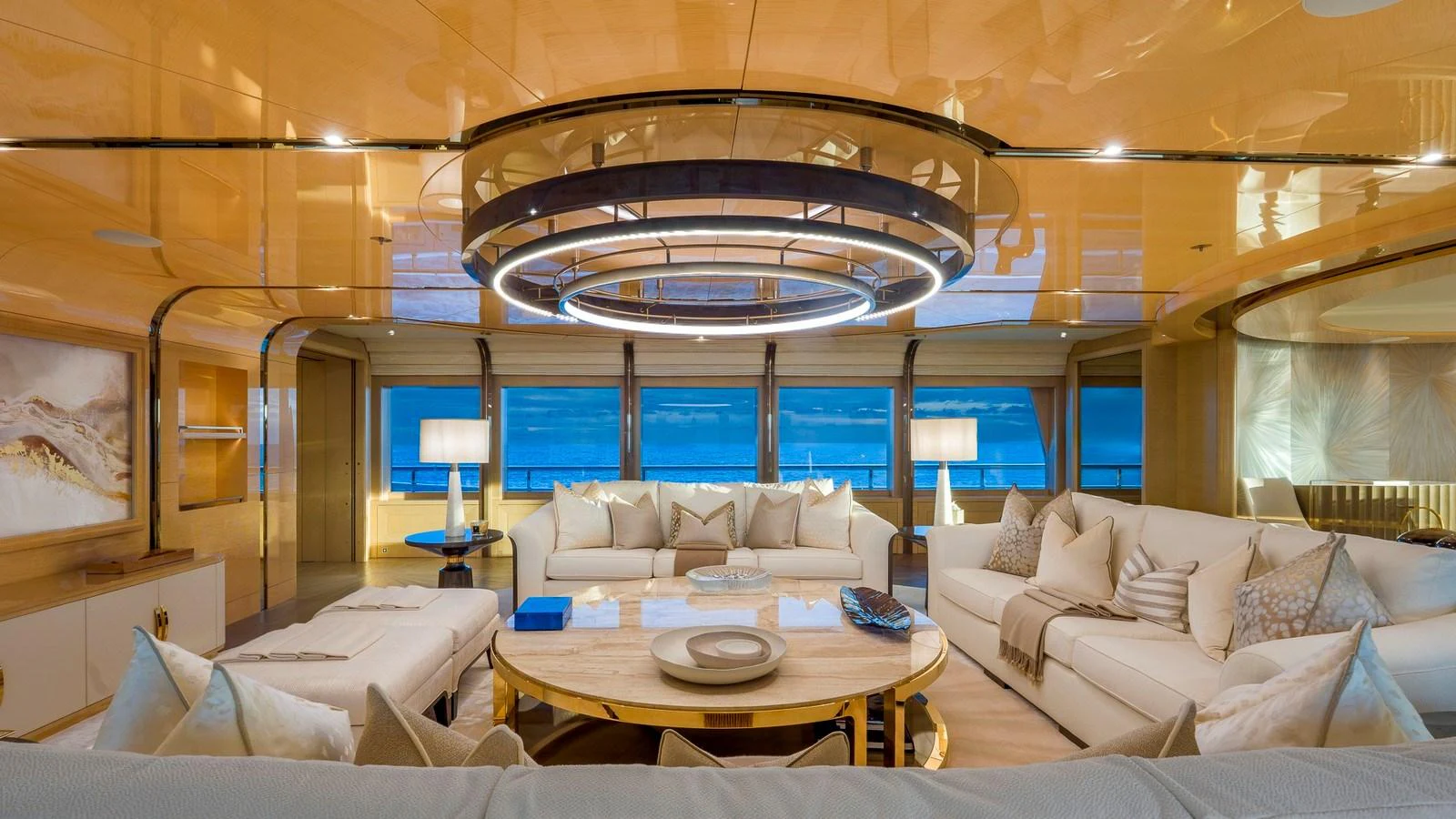 The yacht's salon features luxurious seating and elegant decor with panoramic windows offering stunning ocean views. aboard NENINKA Yacht for Sale